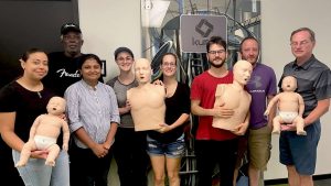 Group CPR training session with mannequins in Nashville.